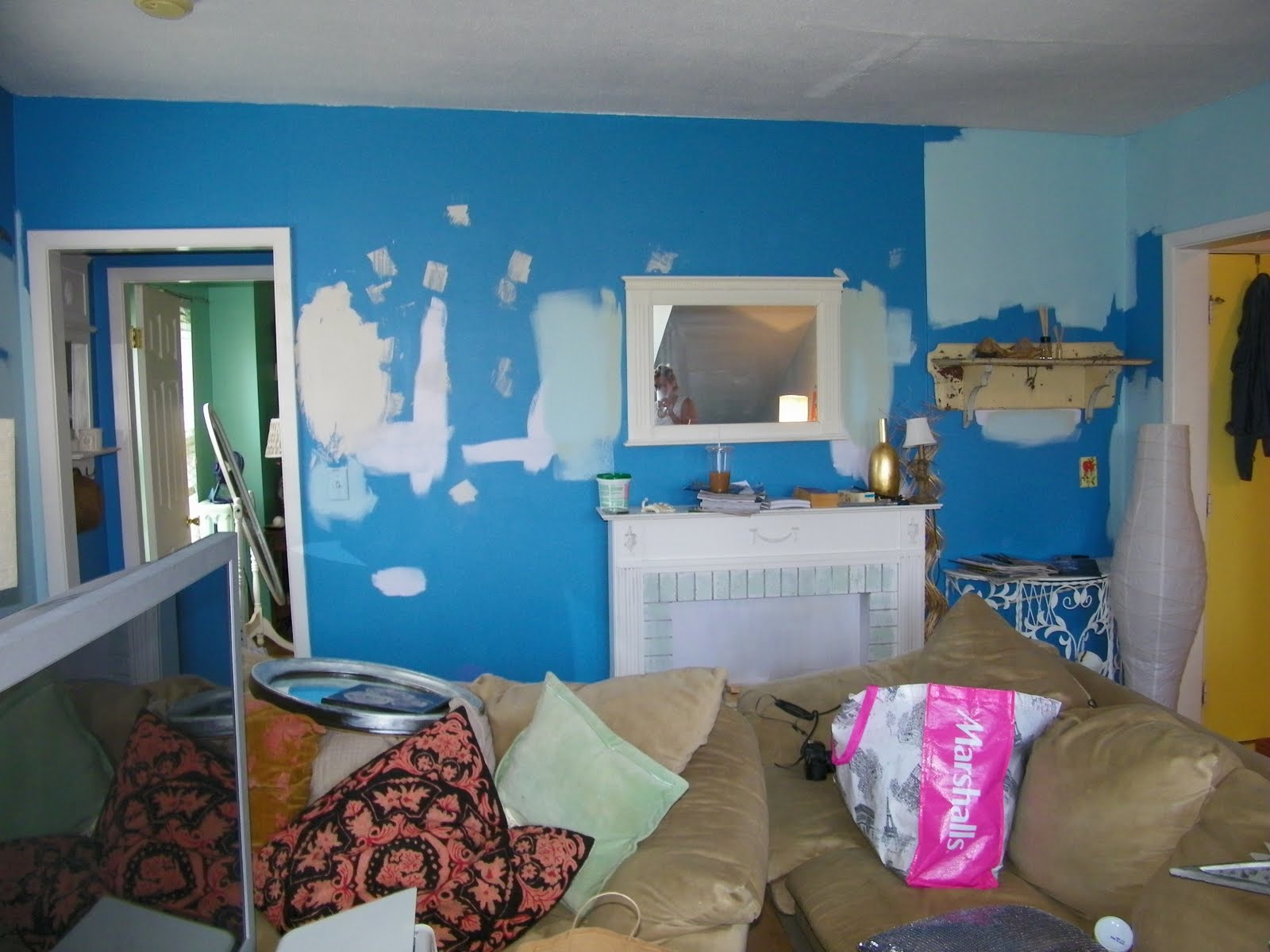 Paint swatches on the wall in tiffany blue shades.