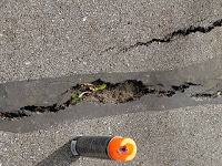 pavement crack wide enough to trap a bicycle wheel