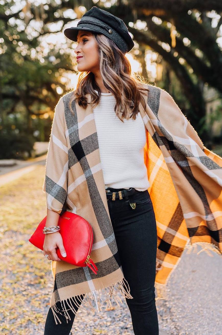 trendy outfit idea with a hat : white sweater + clutch + plaid poncho + skinnies