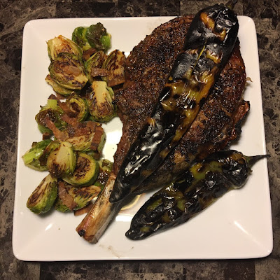 Rare prime bone-in ribeye, fire roasted hatch chiles and bacon roasted Brussels sprouts