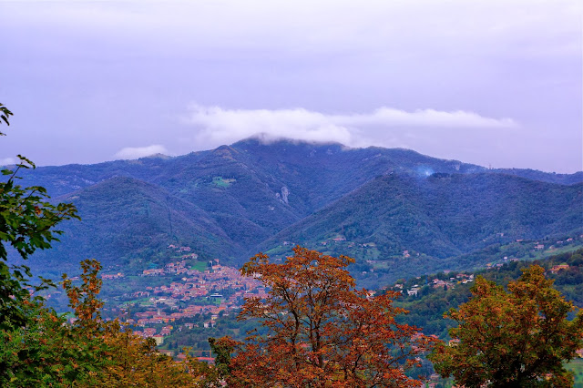 Image of a mountain peak covered by fog near Bergamo, Italy.