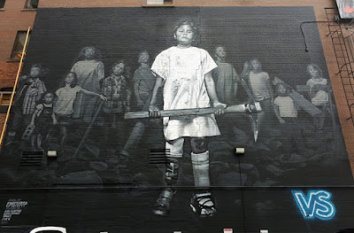 Black and white mural showing children with prosthetics, armed with weapons such as pick-axes and bricks