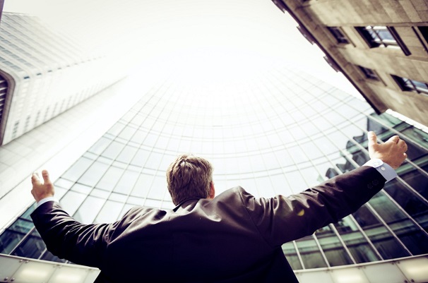 A salesperson is seen celebrating his victory in closing a deal