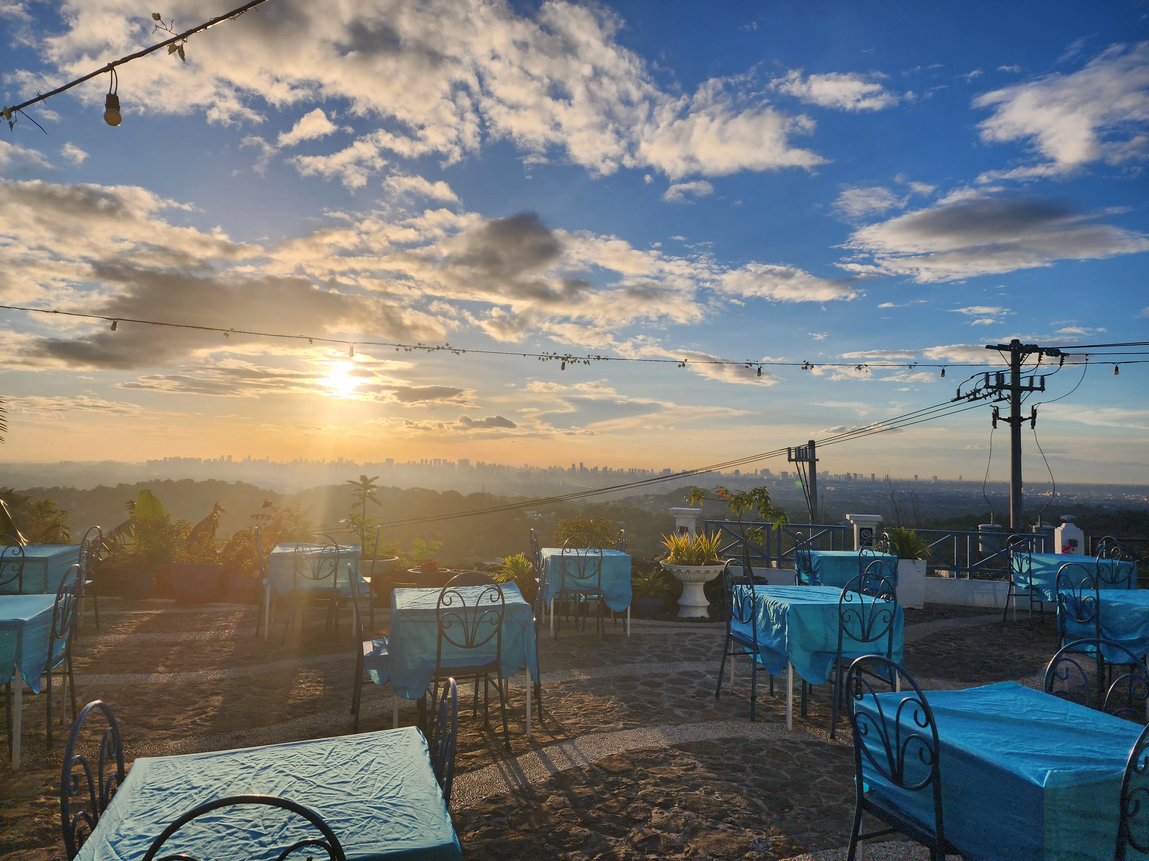 Scenic sunset restaurant tables and chairs and blue sky at Cafe Agusta in Antipolo City Philippines