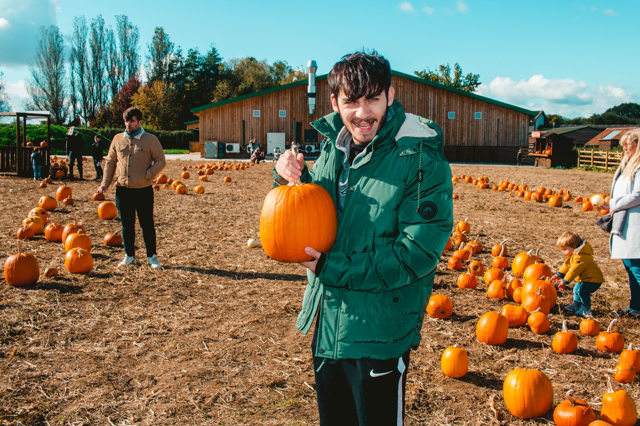 Guy with Autumn Pumpkins at Pumpkin Patch from Fall Pumpkin Picking Autumn Activities Blog Post