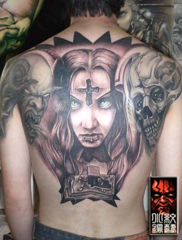 This tattoo design is very cool. It got a wall sculpture inked on the back 