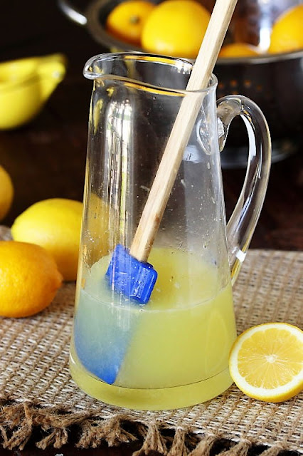 Dissolving Sugar in Lemon Juice to Make Homemade Lemonade Image