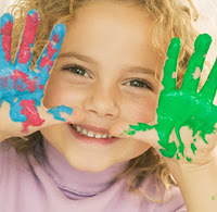 a child with paint on her hands