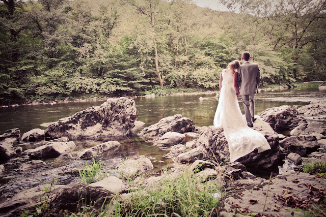 A bride and groom in front of a river in France