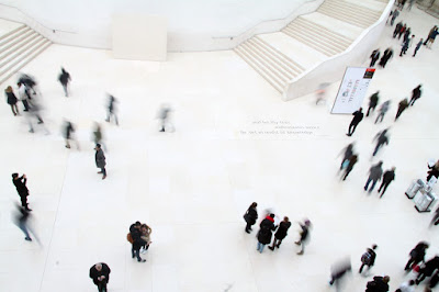 Overhead photo of people moving through a vestibule.