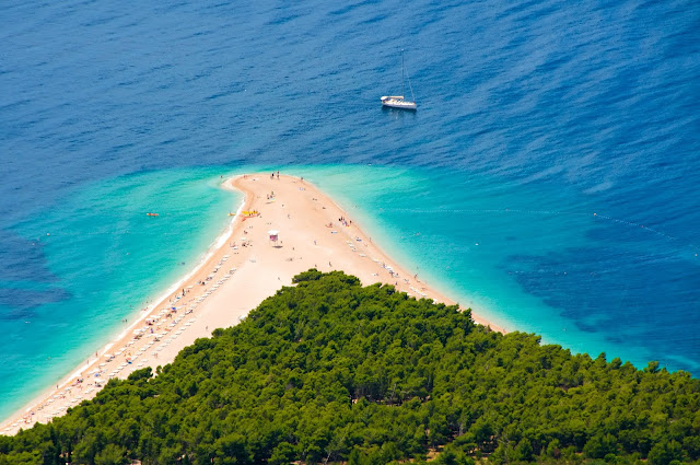 Aerial photography of the a beach whose shape resembles on the horn.