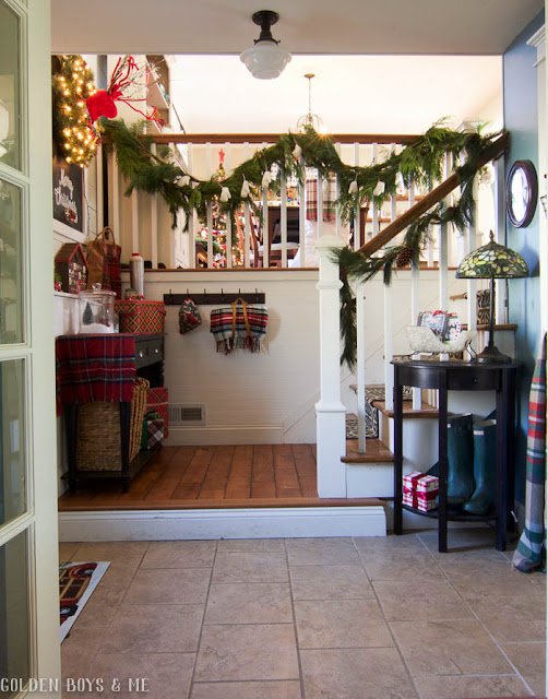 Fresh garland used to decorate entryway in split level home for Christmas