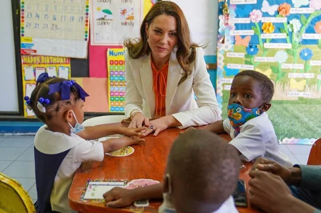 Kate Middleton wore a tangerine silk crepe de chine top by Ridley London, and white crape blazer by Alexander McQueen