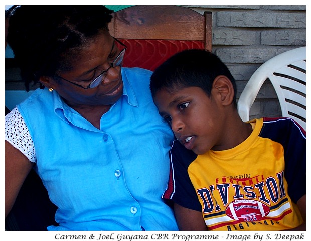 A disabled child with a CBR volunteer, Guyana - Image by S. Deepak