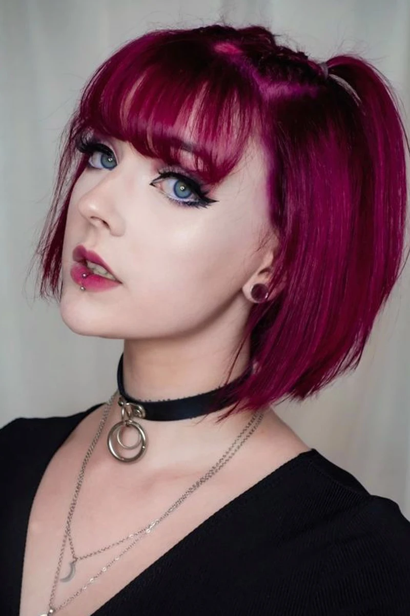 portrait of a beautiful woman with bold makeup look and edgy goth hair