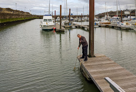 Photo of Phil checking the prawn pot