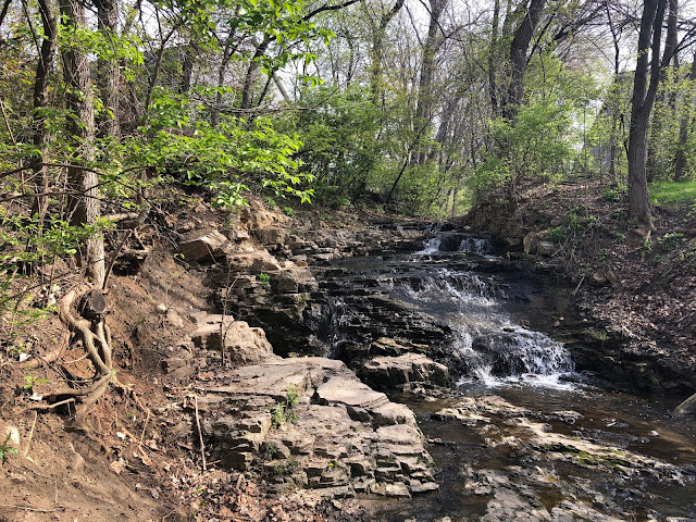 The silver threads of the waterfall in Bettendorf, Iowa shimmer as they tumble.