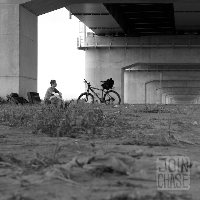 Resting under a highway bridge along the Geum River Bike Path in South Korea.