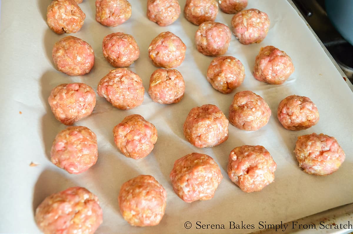 Rolled Meatballs on a piece of parchment paper.