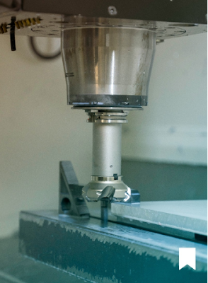 A CNC drilling instrument making drill holes in a machined part