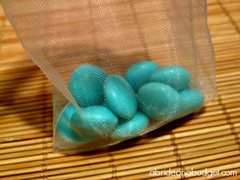Edible favors are a big hit at weddings. You'll love this DIY Ombre Candy Bag Favor from www.abrideonabudget.com. It's super easy to make and your guests will love it!