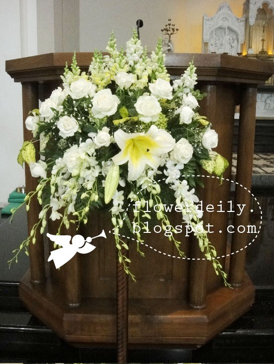 Flower arrangements at the Mary statue and the seven finger candle stand