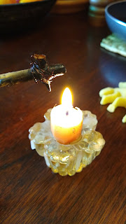 wax dripping tool over a candle