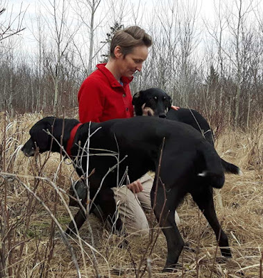 Kristi Benson outdoors with two of her dogs