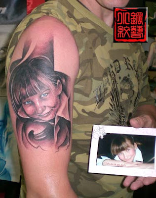portrait of the daughter inked on his arm
