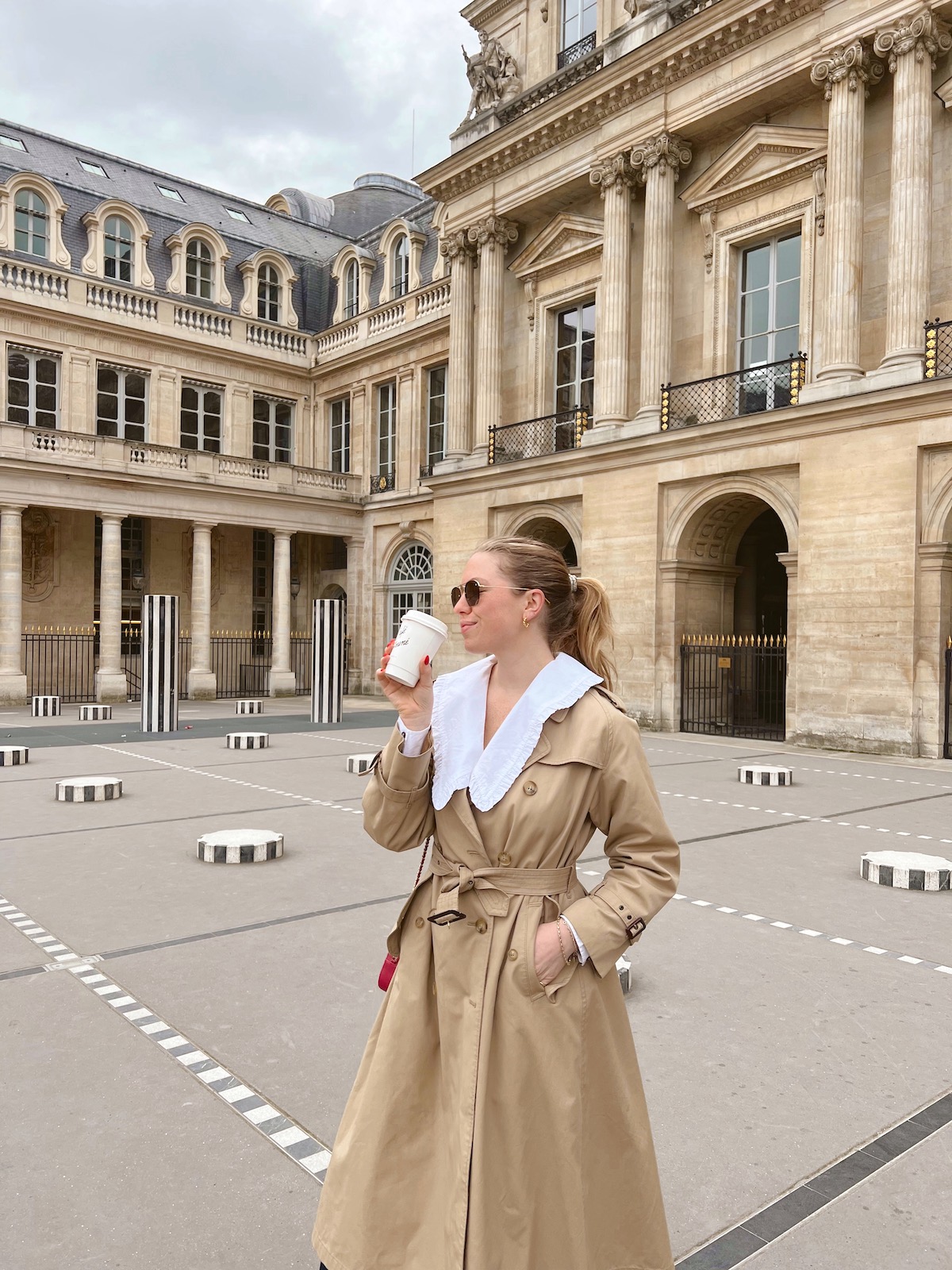 Fran Acciardo 4-Day Paris Itinerary Recap: Fran drinking Cafe Kitsuné coffee at Palais Royal in Paris, France