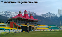 Tour de Dharmshala Stadium - A Quick PHOTO JOURNEY inside the beautiful stadium at Dharmshala, Himachal Pradesh : Posted by VJ SHARMA on www.travellingcamera.com : Last project with HPCA provided a good opportunity to explore interiors of Dharmshala Stadium !!! During the break time of T20 Mahasangram finals, I entered into the stadium to see all the VIP lounges, Team Dressing rooms and other special seatings on top floor !!! Check out the quick Photo Journey inside Dharmshala Stadium !!!Dharamshala Cricket Stadium is aonly cricket stadium of international reputation in Himachal Pradesh !!! It serves as the home ground to the Himachal Pradesh state cricket team and also for the IPL team Kings XI Punjab to a limited extent... By virtue of its natural backdrop (3/5th of the stadium is surrounded by snow covered hills...) it is one of the most attractive cricket stadiums in India.In addition to Ranji matches, some international matches are also planned to be held here.. Dharmshala Stadium is going to host threeIPL macthes in 2011 !!! In 2010, a match between Kings XI Punjab and Chennai Superkings held here in which His Holiness the Dalai Lama graced the match of the Indian Premier League (IPL) at the picturesque Himachal Pradesh Cricket Stadium in Dharamshala. The snow covered mountains can be easily viewed throughout the year.. On entering inside the stadium, there is a huge sitting area with lots of photographs of international cricketers from various parts of the world. And this included cricketers from oldest world cups as well !!! I am not sure how this space is utilized during international matches but on that day tea, snacks and lunch was served in this area...Chairs and Tables are well arranged to serve lunch after closing ceremony of Jaypee T20 Cricket Mahasangram !!! This is same hall on ground floor... Parallel to this hall, there are few VIP lounges which were closed on that day ! Seating arrangement inside looked like modern massage chairs :)Extended part of ground floor hall with all the walls decoraed with Photographs of various cricketers in action !!!Although Dharmshala is naturally very rich place and its completely green, flowers and green plants are used inside for decorating the stadium !!! Dharmshala Stadium looked very well maintained and minute things were taken care while designing it.. I am not an expert but I was super impressed with the quality of work saw there...This was something unexpected :) Dharmshala Stadium has different portions and interiors were completely different in all of those sections.. Some parts were were very sober with all modern fittings and furniture, while other parts looked very royal with all the classic fittings in furniture, walls and roofs...Now I started moving up for first floor of the Stadium and preferred to go through stairs instead of lift ! Whole stair areas are decorated with photographs again but sizes were small which looked perfect in these narrow walls !!! Shiny marble fittings on these stairs were giving a feel of five star hotel.. And yes, waling nside the VIP lounges was really like some five star property !!!Here is a view of back side of Dharmshala Stadium. I am not sure if these appartments are for stadium staff or something else.. and the green grounds on left are used for practice.. A wonderful model of Dharmshala Stadium is installed inside the main building of this campus !!!Conference/Meeting hall of Dharmshala Stadium !!! few software folks from Delhi were waiting for Mr. Anurag Thakur to come and launch website of Himachal Pradesh Cricket association. Launch of this website happened just after final match !!!Another photographs of same area where most of the cricket conferences or meetings take place !!! Note a large projector on the front wall with a Photograph of Dharmshala Stadium on it !!!All the walls and pillars in this room were covered  with leather crafts which looked very nice and gel with overall color combination used for flooring and furniture used in this Conference Hall of Himachal Pradesh Cricket Association Stadium !!!Nextto the Conference Hall, there is a VIP lounge with lot of grouped chairs with marble top tables...  This whole area looked like some royal casino of Las Vegas.. I wanted to capture it better but match was about to start after a short drinks break.. So after few clicks I had to rush to other areas if any !!!Here is another photograph of VIP Lounge on first floor of Dharmshala Stadium !!!There was an adjacent hall which was decent and looked not that lavishing... But it was also closed area with decent air-conditioning... I am not sure who uses these halls/rooms during matches but after looking at India-Pakistan Semi-finals, it seemed that area shown in above photograph must be used by our leaders like Chief-Minister/Prime-Minister oe some other important people in our democracy system !!!A nice mirror was lying in the common hall which was connected to VIP Lounge, Conference/meeting Hall,  and other parts which were closed at that point of timeWith this, my quick tour of 10 minutes completed and moved back tothe ground to capture electrifying actions of finalist teams of Jaypee T20 cricket Mahasangram !!!After looking at wonderful interiors of Dharmshala Stadium, I had a question that why international matches are not played in this stadium.. Last year only one IPL match help here... During the closing ceremony of T20 Mahasangram, Mr. anurag Thakur cleared by doubt. because of hospitality services in Dharmshala, international matches can't be played here. Dharmshala has not enough good standard hotels and keeping this in mind HPCA (Himachal Pradesh Cricket Association) has started constructing a Five Star Hotel there !!