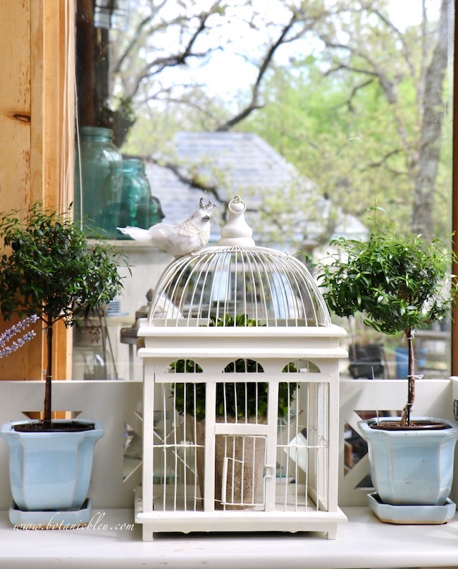 French inspired white bird cage for spring decorating in a country house sunspace