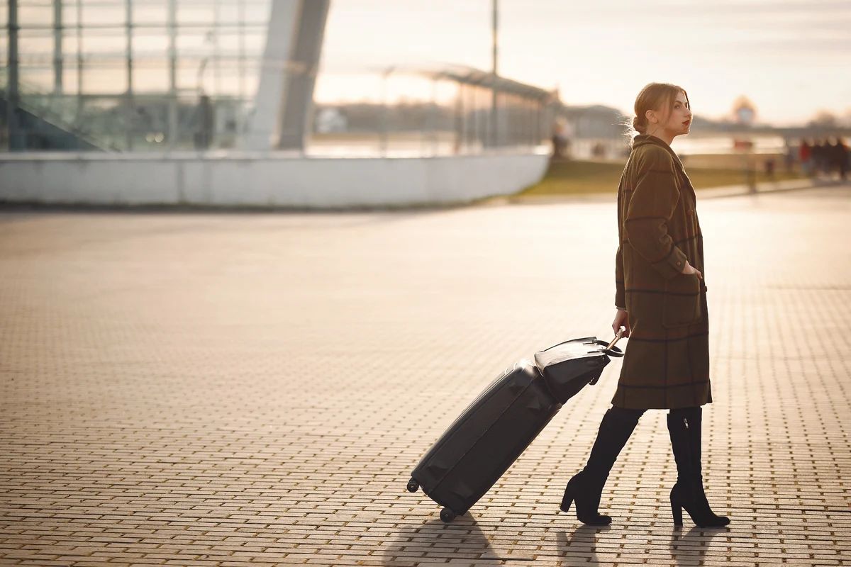 woman in an airoport with a luggage