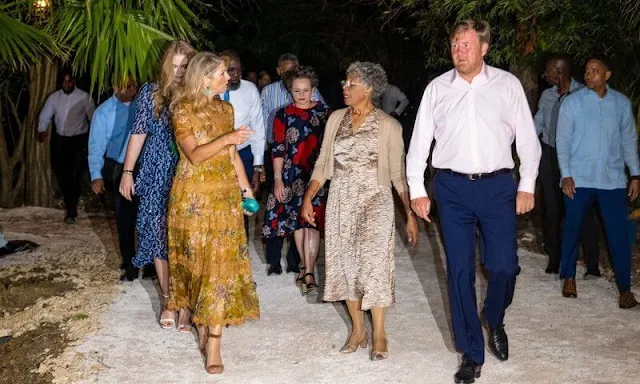 Queen Maxima in Zimmermann mustard floral tropicale crinkle dress. Princess Amalia in LaDress Naomi chiffon crepe maxi dress