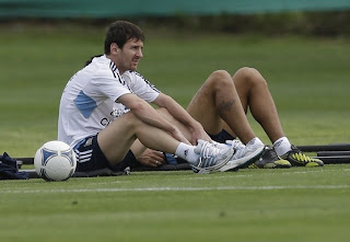 Lionel Messi sitting on ground