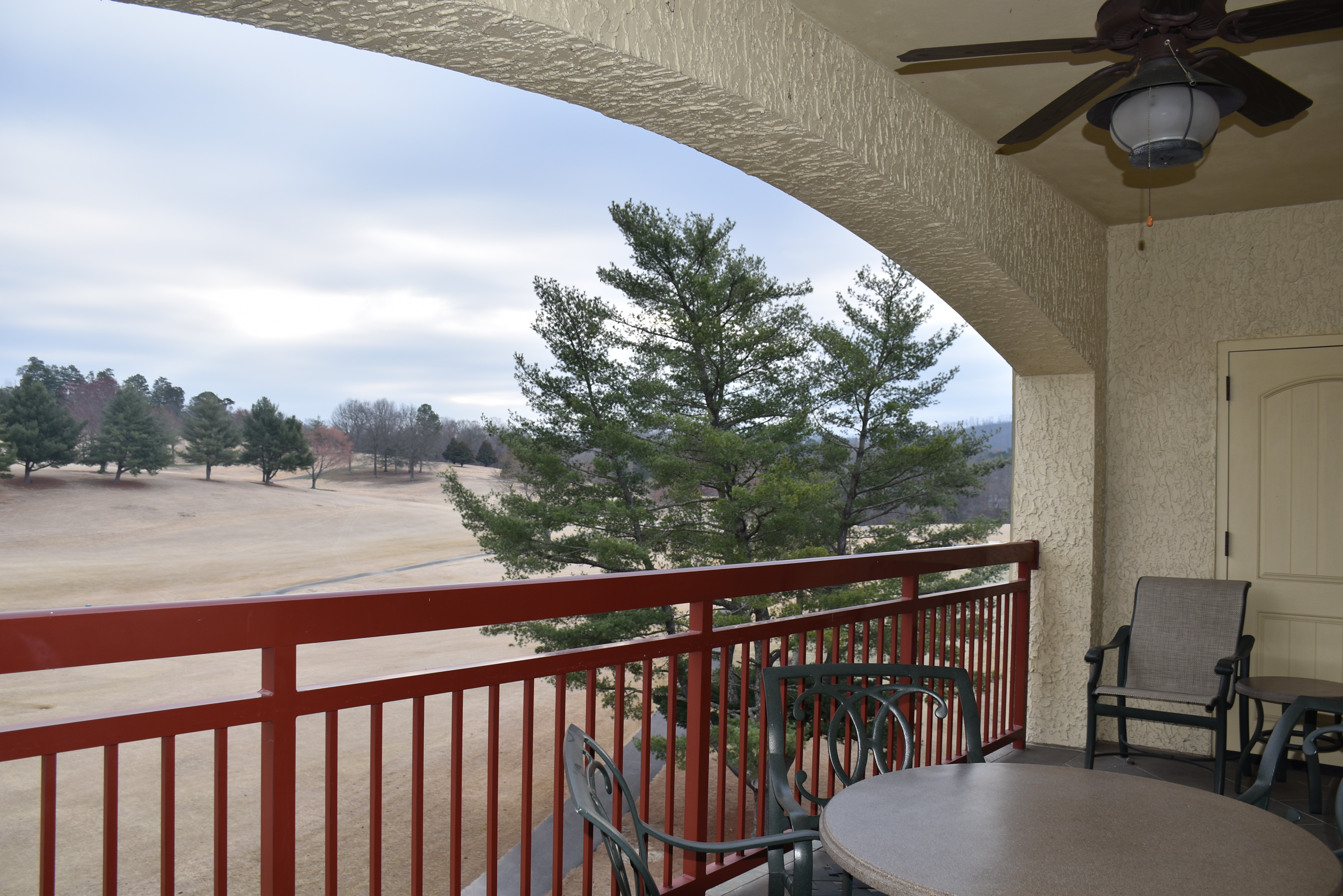 Balcony overlooking the golf course at Riverstone Resort & Spa