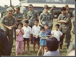 american and s vietnamese soldiers watching children