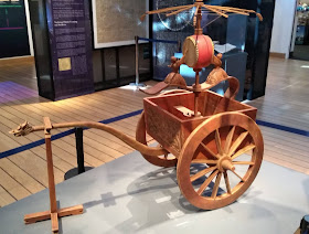 pull along wooden cart with two figures and a drum on top