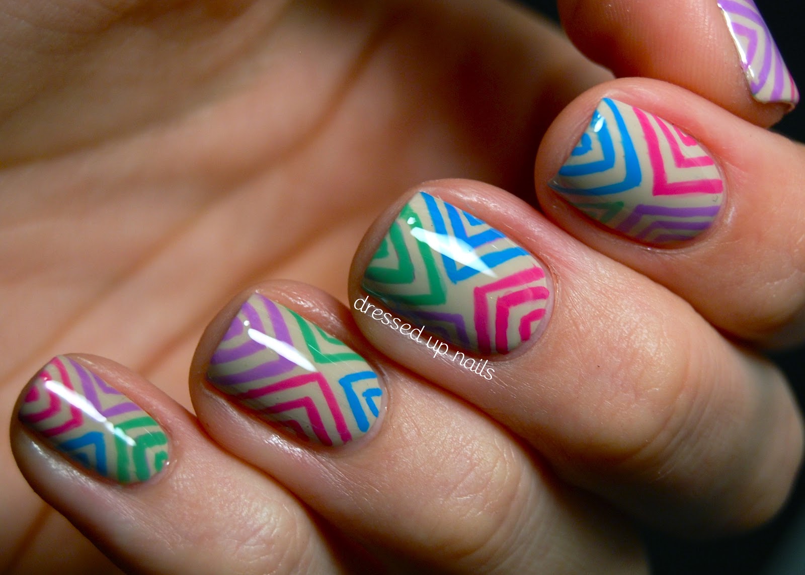 Dressed Up Nails: Colorful offset chevron nail art on a nude base 