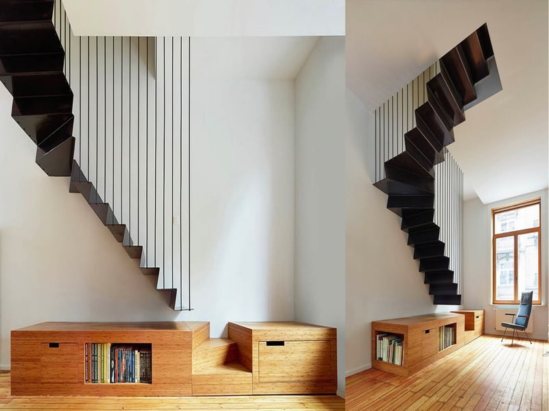 Tích hợp cầu thang vào phòng bằng cách kết hợp nó với đồ nội thất. Thiết kế cầu thang treo màu đen này dừng lại ở gần sàn nhà, nơi một vài thanh gỗ cuối cùng được kết hợp thành một tủ lưu trữ thấp với các ngóc ngách để sách.