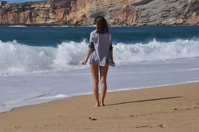 Girl on Nazare beach in Portugal.