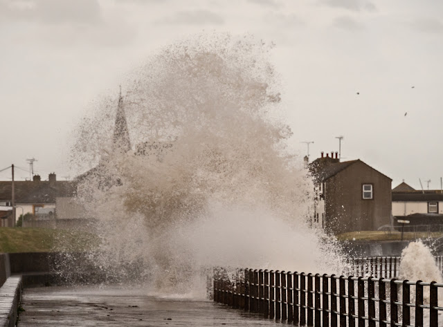 Photo of waves crashing onto  Maryport promenade