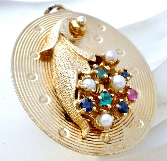  14K gold cornucopia pendant can be found here.