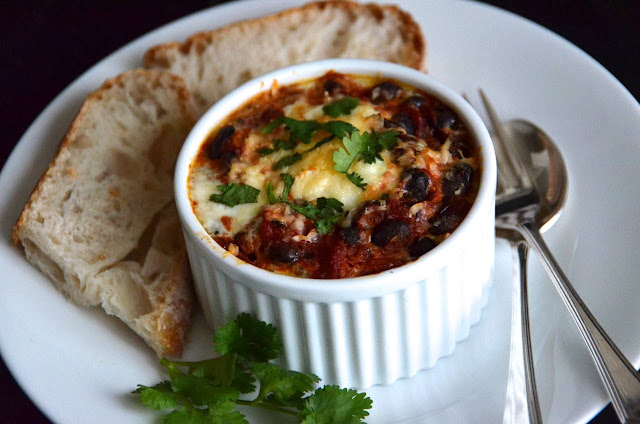 MEXICAN BAKED EGGS WITH BLACK BEANS, TOMATOES, CHILLI AND CORIANDER