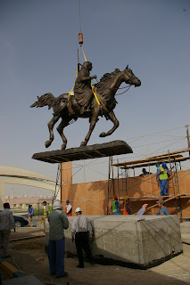   The bronze horse sculpture being placed on the pedestal.