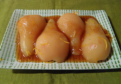 Plate of Poached Pears topped with Sauce and Lemon Zest