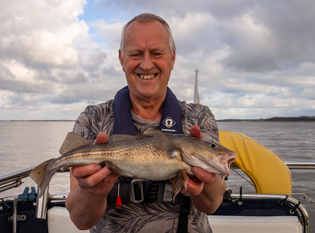 Photo of Phil with the first and largest cod he caught on this trip