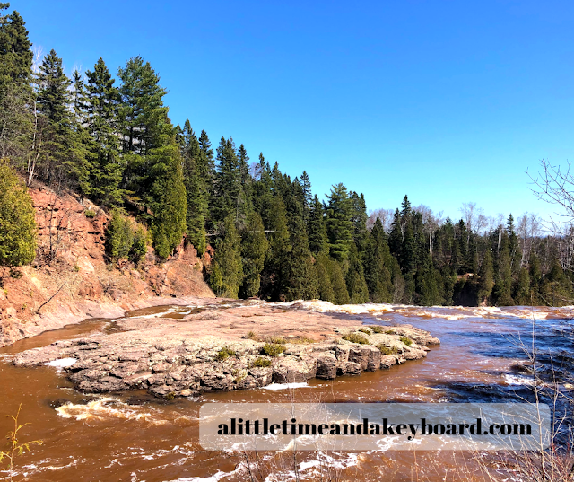 Rolling rapids surrounded by verdant evergreens at Gooseberry Falls State Park in Minnesota.