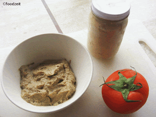 Freshly made chicken liver pâté in a bowl, tomato