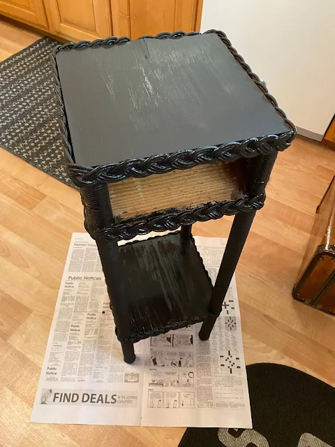 Photo of a wood & wicker plant stand being painted black